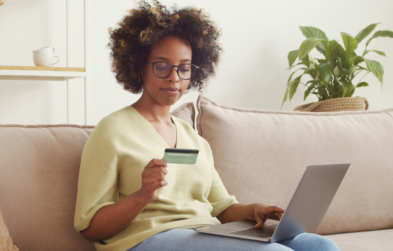 Black woman using laptop to make an online payment