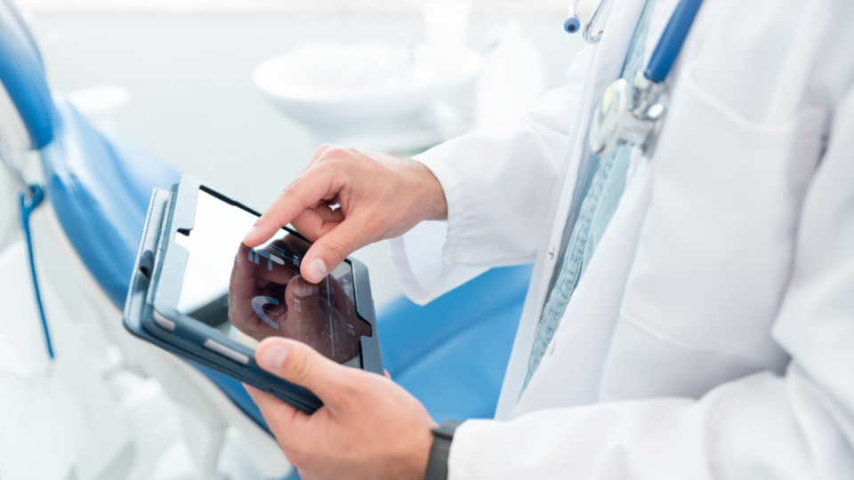 Doctor looking at patient chart in tablet.